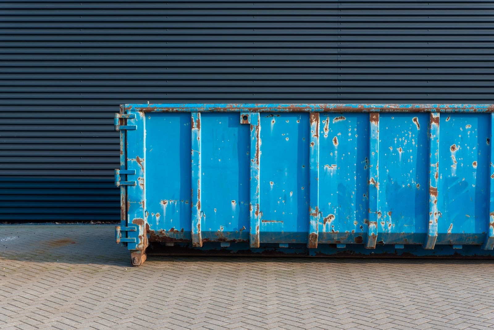 A clean roll-off disposal bin delivered and ready to load